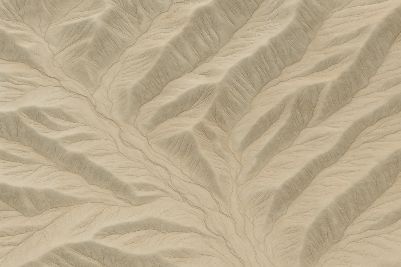 Aerial view of eroded arid terrain, dry riverbeds and ridgelines forming natural contour patterns